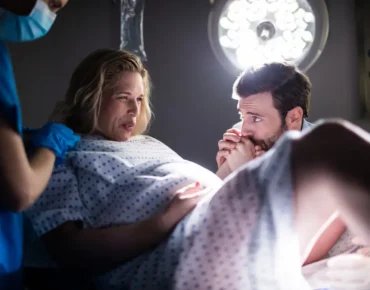 Pregnant woman discussing normal delivery and cesarean section options with a gynecologist