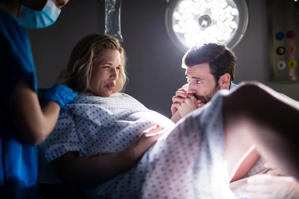 Pregnant woman discussing normal delivery and cesarean section options with a gynecologist