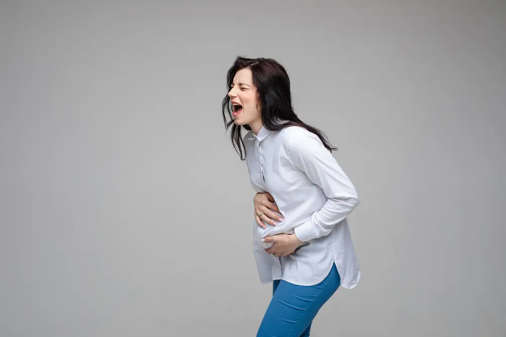 Pregnant woman experiencing severe abdominal pain indicating dangerous pregnancy symptoms